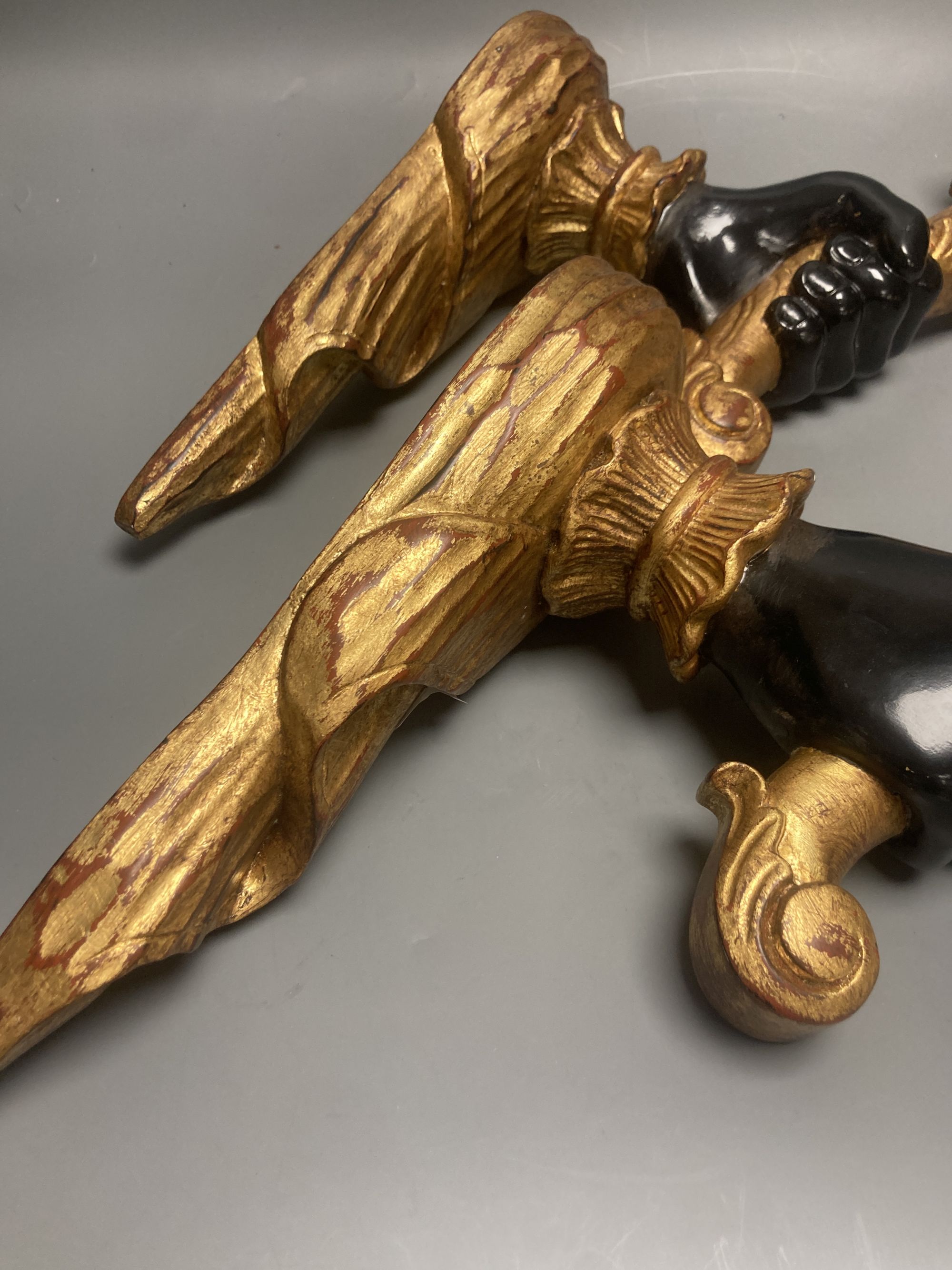 A pair of gilt and ebonised carved wood hand and cornucopia wall sconces, height 52cm not including light fitting